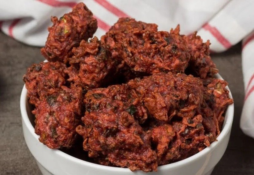 A bowl of crispy Chinese Pakoda, deep red from beetroot, made by Siddhi Panchal without food colour