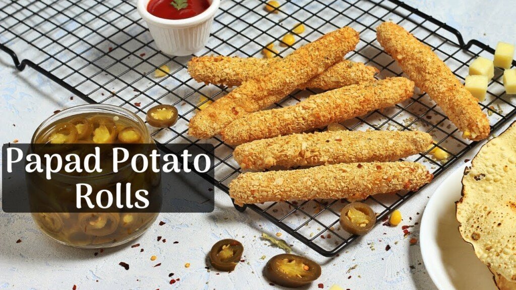 Crispy Papad Potato Rolls on a cooling rack with jalapeños and ketchup, made by Siddhi Panchal