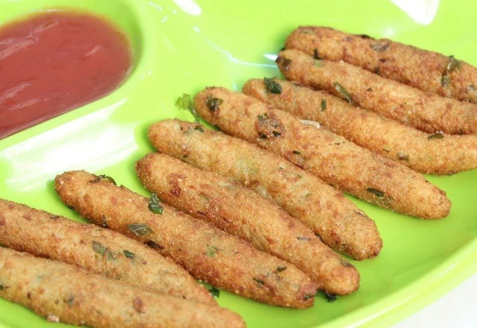 Crispy potato suji fingers on a green plate with ketchup