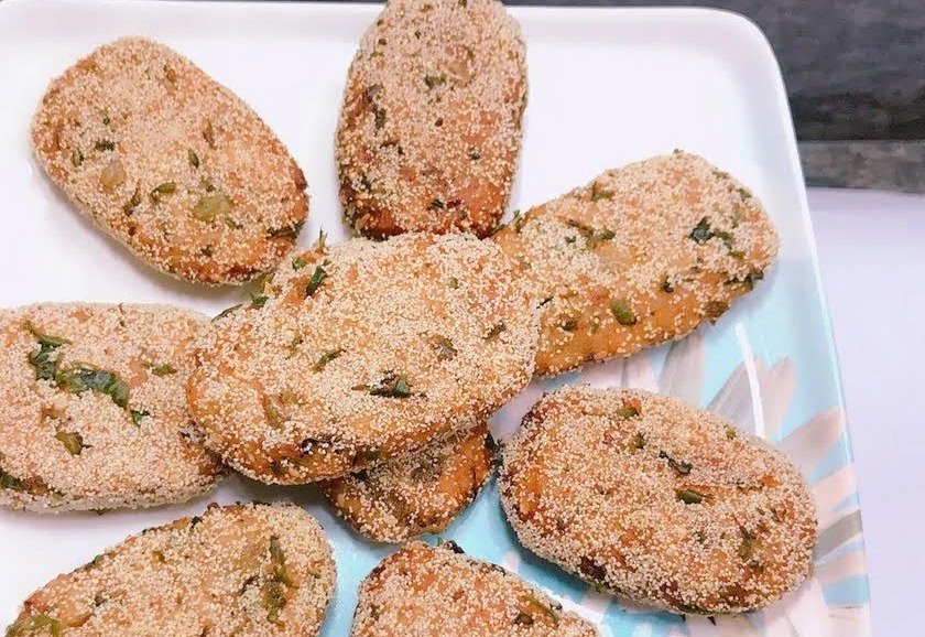 Semolina-coated rice cutlets arranged on a white plate